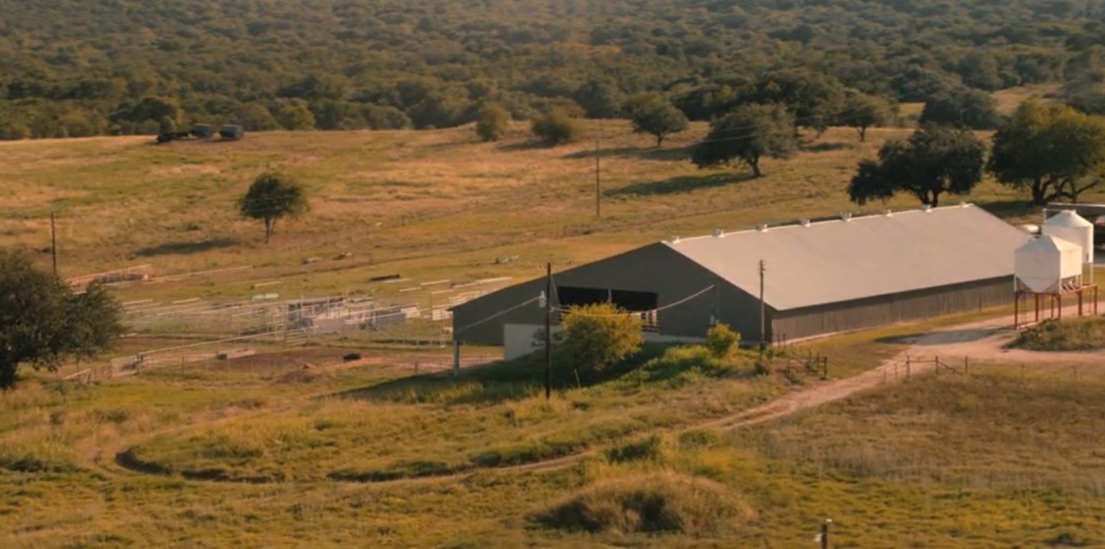 Aerial view of ranch barns and pasture on the working land